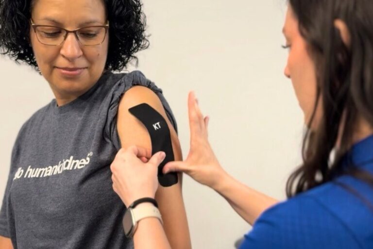 KT tape a physical therapist putting KT tape on a shoulder