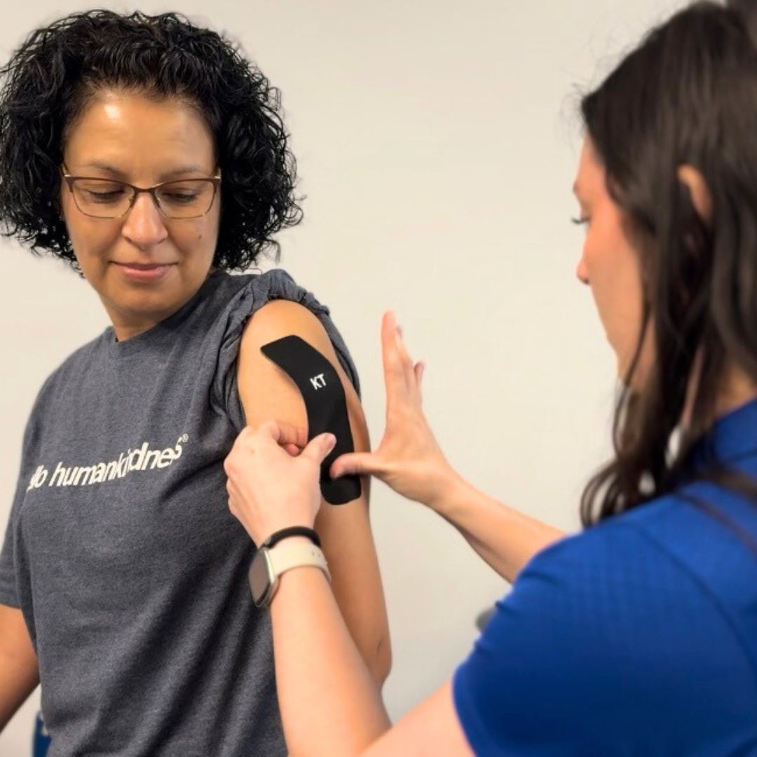KT tape a physical therapist putting KT tape on a shoulder